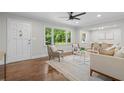 Bright living room featuring hardwood floors, neutral paint, ceiling fan and large windows offering ample natural light at 3180 Rehoboth Dr, Decatur, GA 30033