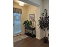 Welcoming entryway featuring hardwood floors and decorative plants at 7699 Cabrini Pl, Fairburn, GA 30213