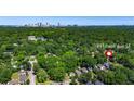 Aerial view of property showing a charming neighborhood and wooded areas with Atlanta skyline in the distance at 891 Paoli Se Ave, Atlanta, GA 30316