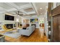 Bright living room with fireplace, coffered ceiling, hardwood floors and modern furnishings at 891 Paoli Se Ave, Atlanta, GA 30316