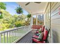 Relaxing covered porch view with chairs, swing, and hanging plants overlooking the lawn at 891 Paoli Se Ave, Atlanta, GA 30316