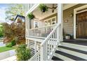 Close-up of the front porch with a wooden door, stairs, and porch railings at 891 Paoli Se Ave, Atlanta, GA 30316