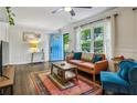Cozy living room featuring stylish decor, hardwood floors, wainscoting detail, and natural light from the windows at 1410 Cobb Branch Dr, Decatur, GA 30032