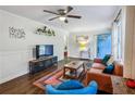 Stylish living room featuring hardwood floors, modern decor, wainscoting, and neutral wall colors at 1410 Cobb Branch Dr, Decatur, GA 30032