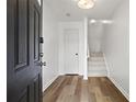 Bright entryway featuring hardwood floors and a staircase leading to the upper level at 4044 Spring Cove Dr, Duluth, GA 30097