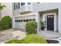 Inviting home exterior featuring a garage, manicured bushes, and a welcoming entrance at 4044 Spring Cove Dr, Duluth, GA 30097