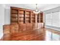 Spacious living room with custom shelving and a bright window at 740 Creek Wind Ct, Duluth, GA 30097