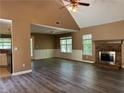Inviting living room with a stone fireplace, new flooring, and ample natural light for a warm atmosphere at 1280 Waterwood Dr, Loganville, GA 30052