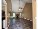 Spacious living room boasts vaulted ceilings, a fan, and a stone fireplace, perfect for cozy evenings at 1280 Waterwood Dr, Loganville, GA 30052