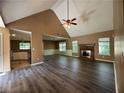 The open-concept living room features beautiful flooring, a fireplace, and abundant natural light from large windows at 1280 Waterwood Dr, Loganville, GA 30052