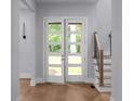 Bright foyer with hardwood floors, stairs, and natural light from the front door at 1604 Niskey Lake Rd, Atlanta, GA 30331