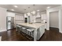 Spacious kitchen with granite counters, stainless steel appliances, and large center island at 3317 Sweetleaf Ln, Buford, GA 30519