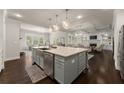 Open kitchen featuring a large island, stainless steel appliances, and views of the living room at 3317 Sweetleaf Ln, Buford, GA 30519