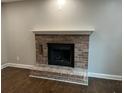 Close up of the fireplace in the living room features brick surround and hearth at 743 San Fernando Se Dr, Smyrna, GA 30080