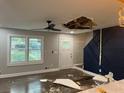 Spacious living room with large windows, stylish accent wall, and hardwood floors at 743 San Fernando Se Dr, Smyrna, GA 30080