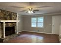 Bright living room with a stone fireplace as a focal point and a view to the front yard at 1978 Winding Creek Sw Ln, Marietta, GA 30064