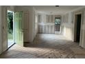 Open-concept living room boasts raw wood flooring, freshly prepared walls, and a doorway to the outside at 3831 Dillard St, Powder Springs, GA 30127
