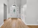 Bright foyer with hardwood floors, wainscoting, and a decorative front door at 4801 Devonhurst Way, Powder Springs, GA 30127