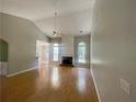Bright living room features gleaming hardwood floors, fireplace and windows with views to the backyard at 4801 Devonhurst Way, Powder Springs, GA 30127