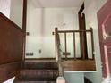 View of a wooden staircase with a partially damaged railing at 816 Cedar Lake Se Dr, Conyers, GA 30094