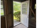 A view through the doorway to the yard in the unfinished room with exposed framing at 2039 Harwinor Se Rd, Smyrna, GA 30082