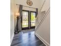 Inviting entryway with stylish wood-look flooring, elegant staircase, and an ornate glass double door at 2689 Muskeg Sw Ct, Atlanta, GA 30331