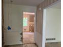 Hallway leading to gutted kitchen with light and neutral color walls at 3511 Brookview Dr, Marietta, GA 30068