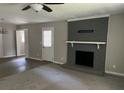 Spacious living room featuring a brick fireplace, ceiling fan, and ample natural light at 6512 Executive Dr, Winston, GA 30187
