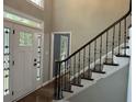 Welcoming foyer with decorative glass front door and staircase with iron spindles leading upstairs at 730 Redlion Run, Alpharetta, GA 30022