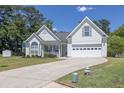 Charming two-story home with well-manicured lawn, attached garage, and inviting front porch at 2780 Matlin Way, Buford, GA 30519