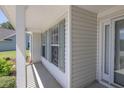 Inviting covered front porch with detailed trim work and natural light streaming through windows at 2780 Matlin Way, Buford, GA 30519