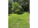 The backyard features a large green open space with a tree at 309 E Rhinehill E Rd, Atlanta, GA 30315