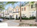 Inviting exterior view of townhome featuring a well-kept lawn and neutral-toned facade at 6073 Camden Forrest Dr, Riverdale, GA 30296