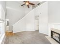 Bright living room features neutral paint, carpet and fireplace with natural light at 6073 Camden Forrest Dr, Riverdale, GA 30296