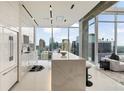Modern kitchen with marble island, stainless appliances, and panoramic city views from the floor-to-ceiling windows at 860 Peachtree Ne St # 2801, Atlanta, GA 30308