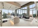 Bright, open living space with floor-to-ceiling windows offering stunning city views and a modern kitchen at 860 Peachtree Ne St # 2801, Atlanta, GA 30308