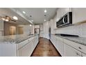 Modern kitchen featuring stainless steel appliances, granite countertops, and ample cabinet space at 9866 Garden Hill Ln, Douglasville, GA 30135