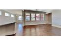 Spacious living room with hardwood floors, and large windows at 9866 Garden Hill Ln, Douglasville, GA 30135