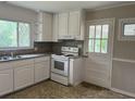 Kitchen with white cabinets, white appliances, granite counters, and a window above the sink at 172 Camp Sunrise Nw Rd, Cartersville, GA 30121