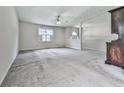 Expansive carpeted basement area with bright windows and a rustic decorative cabinet at 301 Jetta Ln, Canton, GA 30115