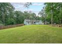 Expansive backyard with lush lawn and tree line, perfect for outdoor activities at 58 First Manassas E Way, Sharpsburg, GA 30277