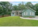 Charming home features a well-manicured lawn and appealing stone accents at 58 First Manassas E Way, Sharpsburg, GA 30277