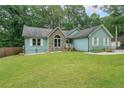 Charming home features a well-manicured lawn and appealing stone accents at 58 First Manassas E Way, Sharpsburg, GA 30277