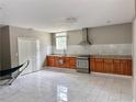 Modern kitchen with stainless steel appliances, granite countertops, and white marble-look tile flooring at 7326 Leland Ln, Jonesboro, GA 30236