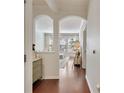 Hallway leading to the bright living room with white sofas and hardwood floors at 1850 Cotillion Dr # 2304, Dunwoody, GA 30338