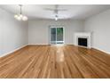 Bright living room with fireplace, hardwood floors, and access to the outdoors at 2031 Austin Park Cir, Decatur, GA 30032
