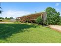 Charming home featuring a green roof, spacious porch, landscaped yard, and scenic views at 220 Mountain Creek Rd, Bowdon, GA 30108