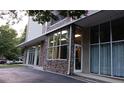 Building's facade featuring stone accents, large windows, and an awning, combining natural materials with modern design at 840 United Se Ave # 408, Atlanta, GA 30312