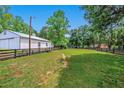 The property includes a spacious white barn nestled in the green landscape at 471 Henderson Lake Dr, Canton, GA 30115