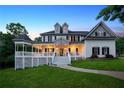 Elegant two-story home featuring a covered porch with ample seating space and manicured landscaping at 471 Henderson Lake Dr, Canton, GA 30115